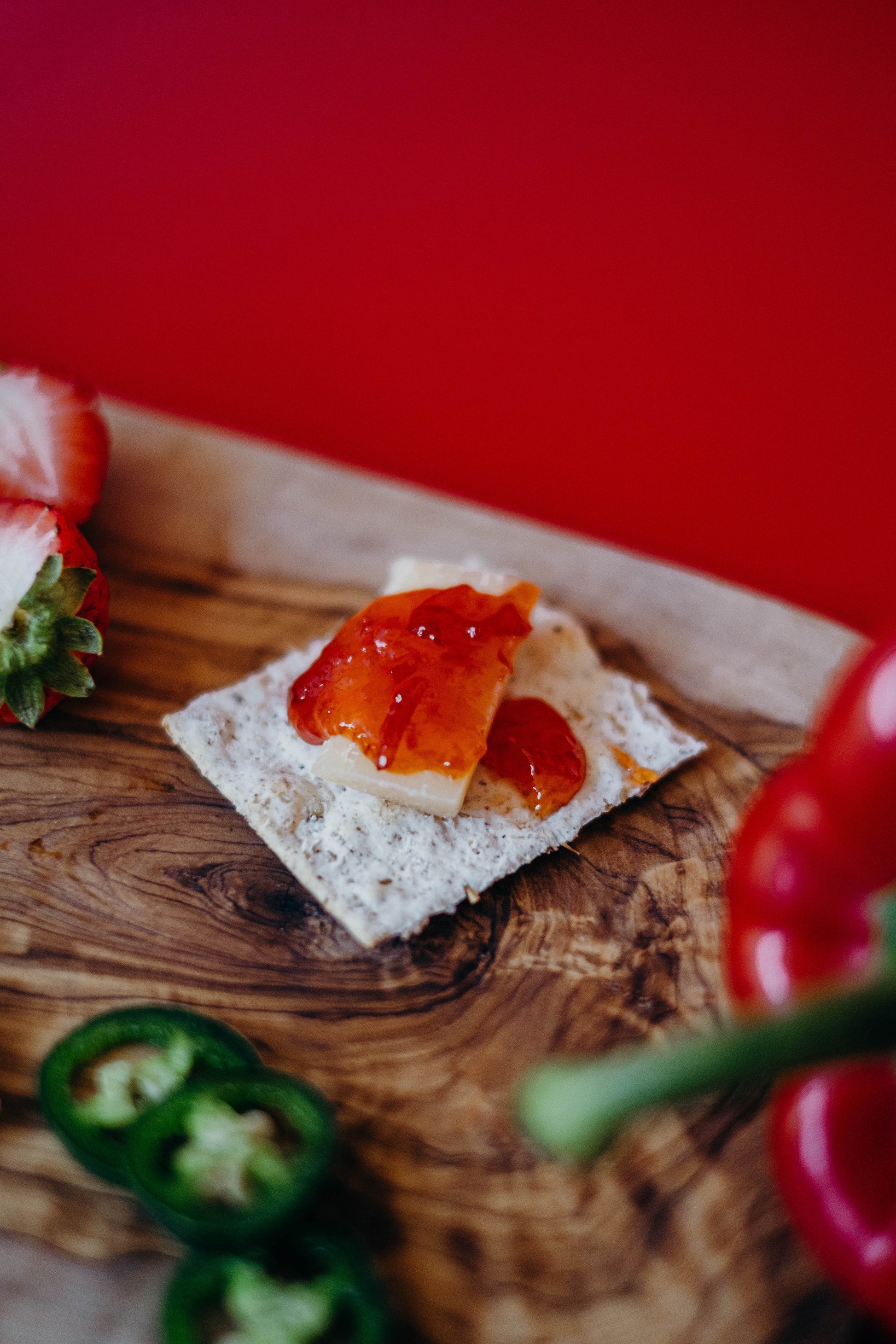 Red pepper jelly on a cracker with cheese